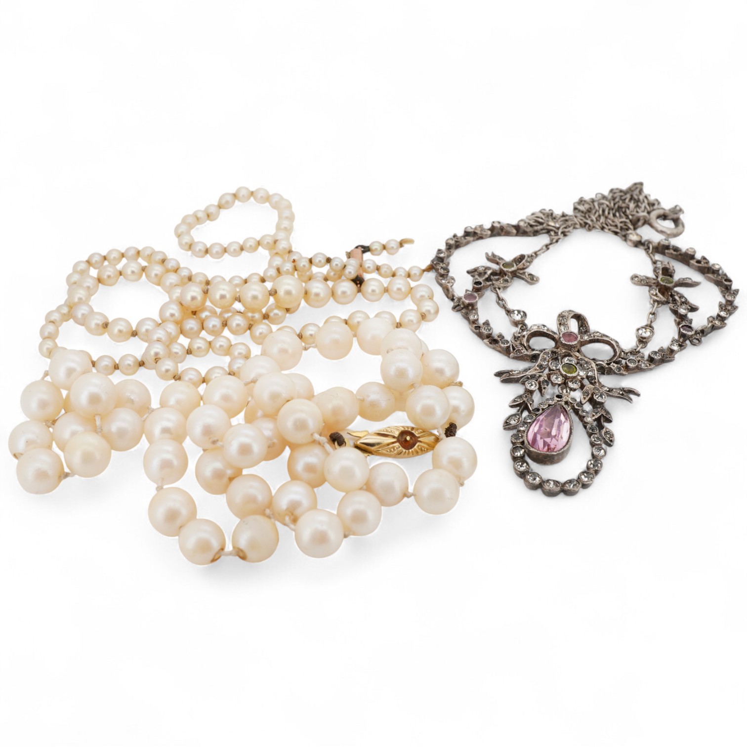 An early 20th century French white metal and three colour paste set drop pendant necklace, 46cm, together with two cultured pearl necklaces, both with 9ct clasps, both approx. 44cm, one a.f.